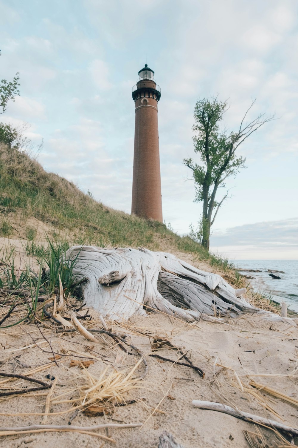 a light house sitting on top of a sandy beach