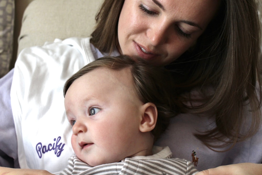 a woman holding a baby in her arms