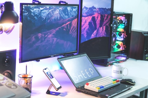 a desk with a laptop and a monitor on it