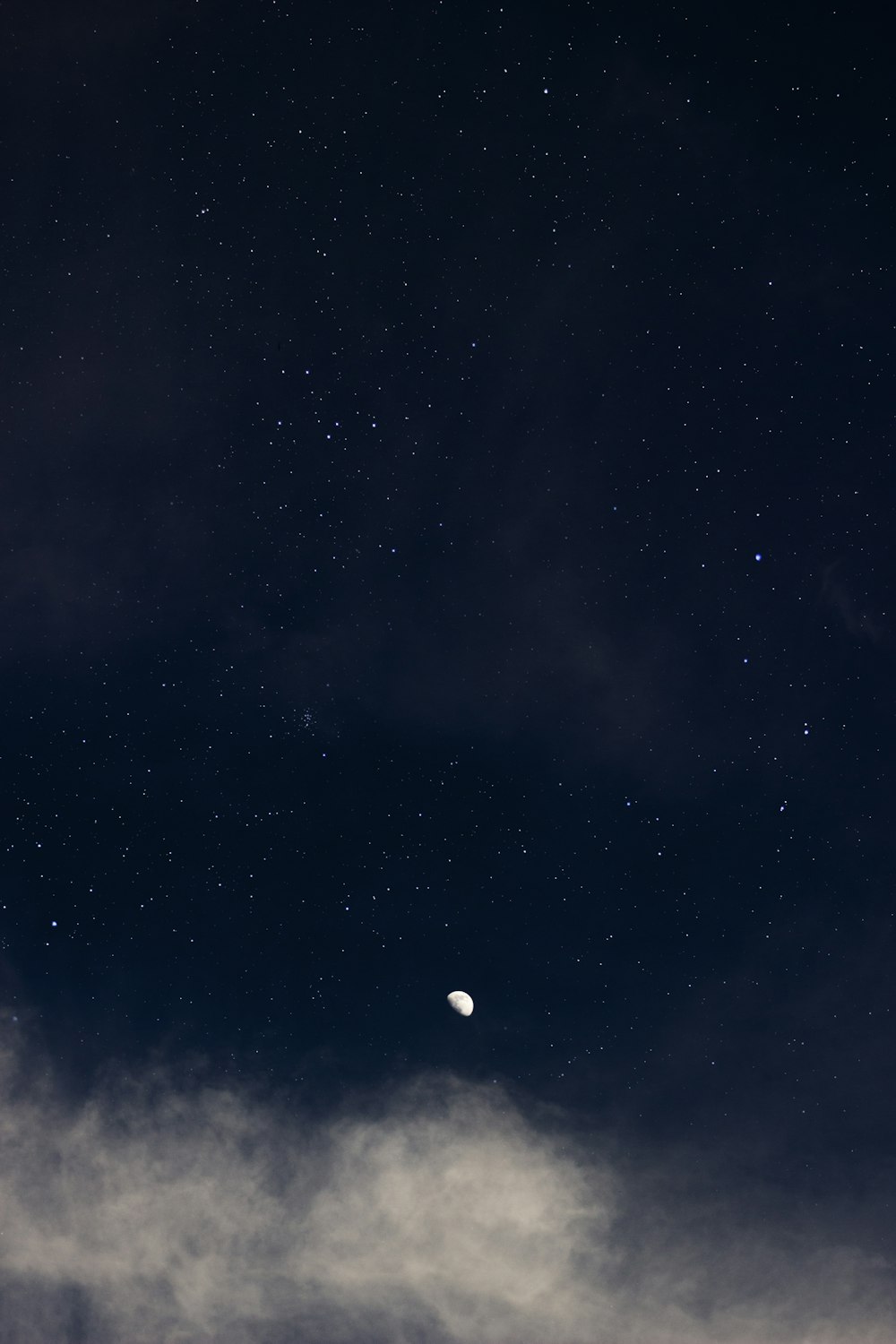 a night sky with the moon and stars