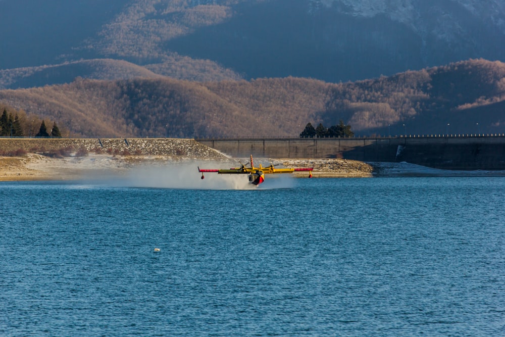 a plane is flying low over a body of water