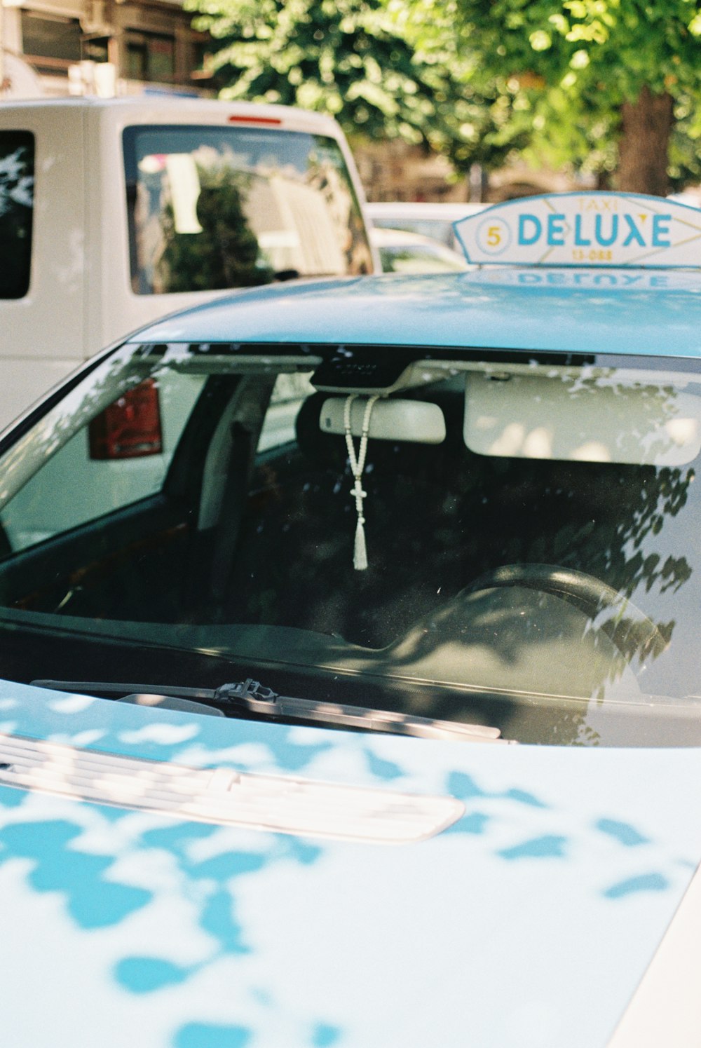 a close up of a parked car near other cars