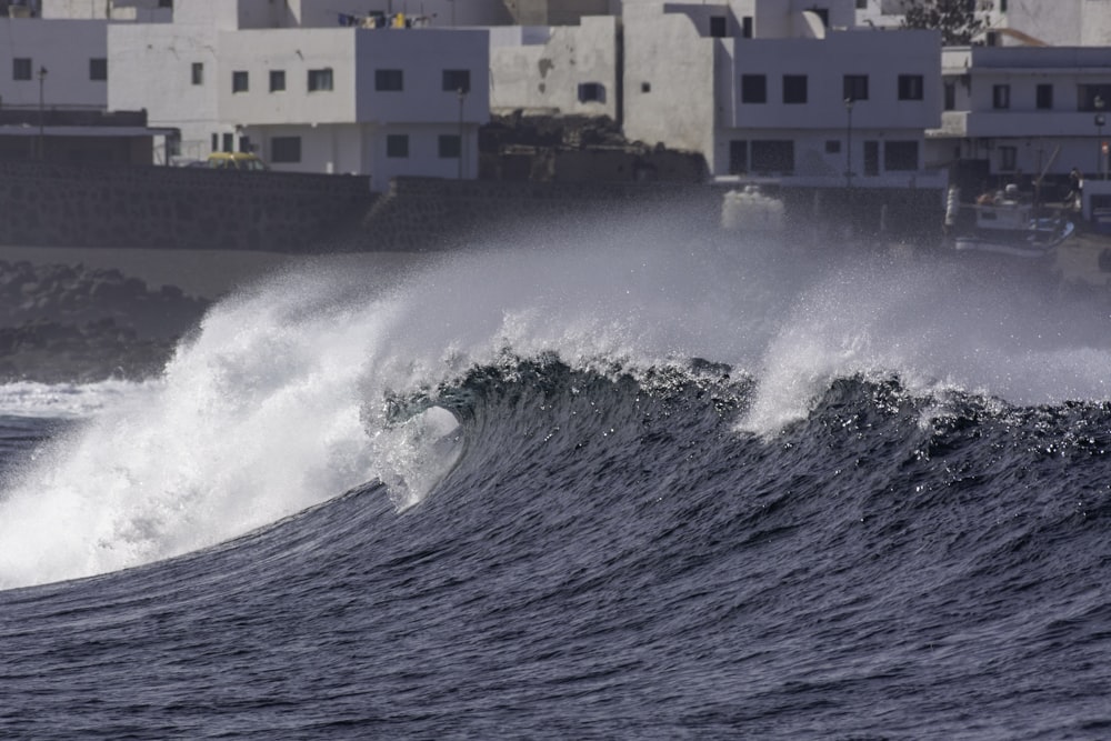 a person riding a wave on top of a surfboard