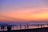 Smiling travelers enjoying a scenic beach sunset during a tropical vacation.