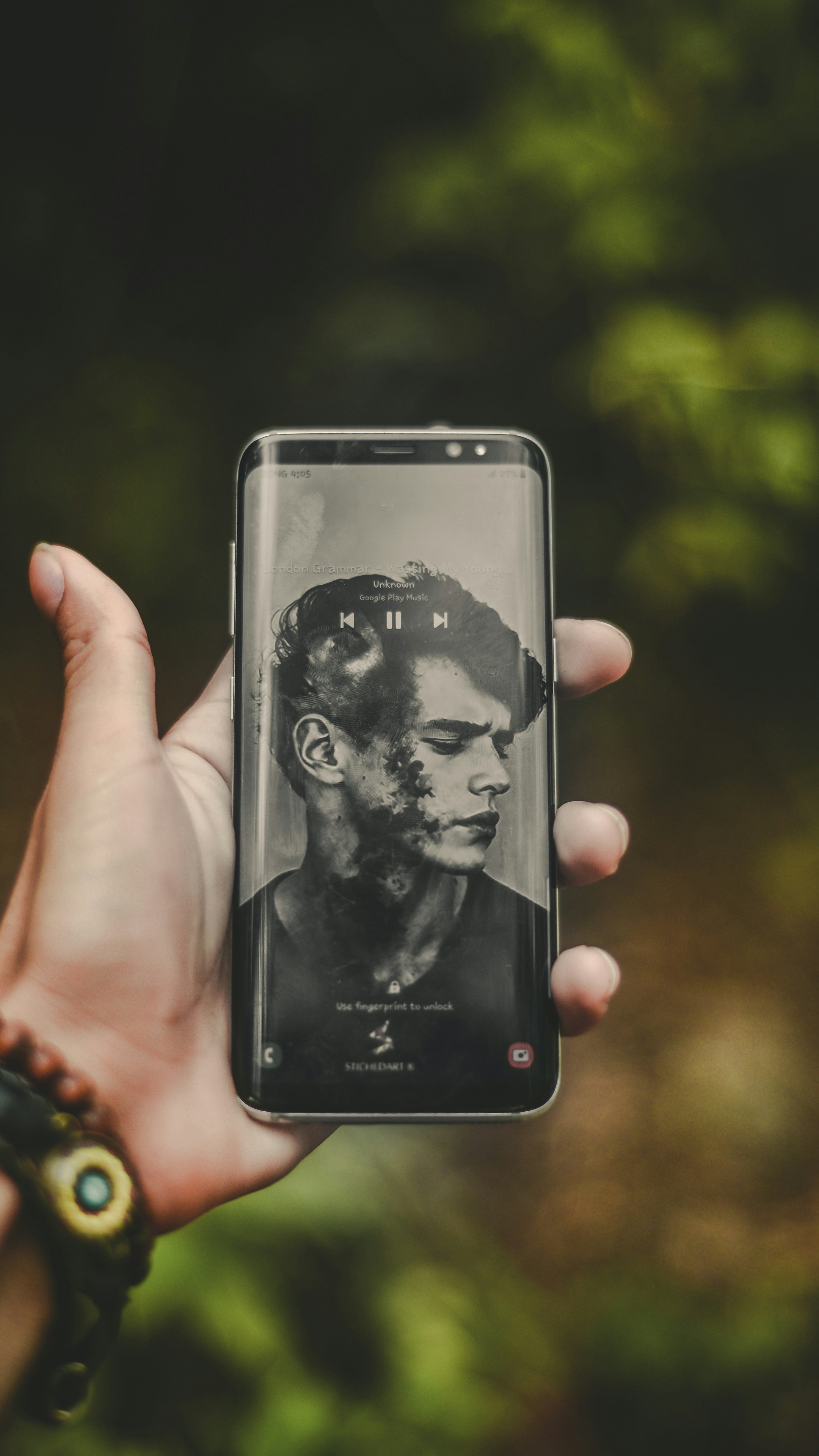 a person holding a cell phone with a picture of a man on it