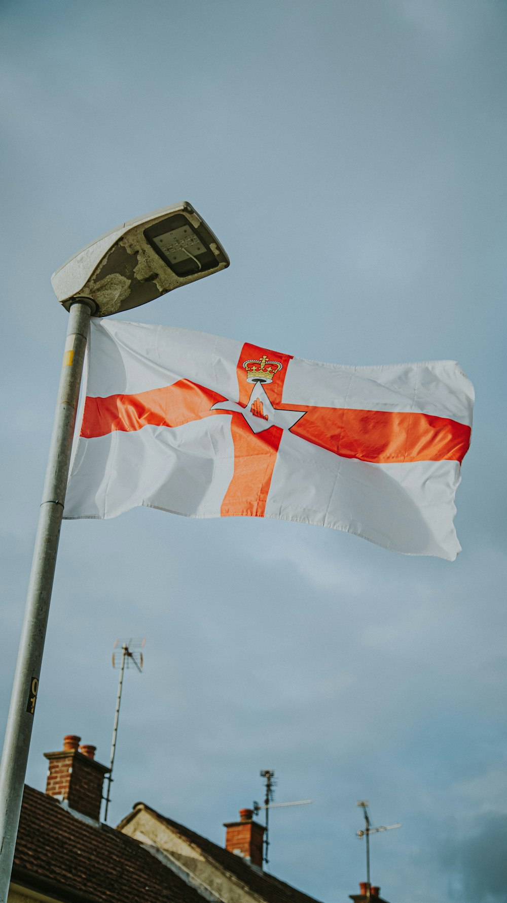 an orange and white flag flying in the wind