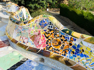 Public bench made of vibrant painted wood reflecting Mexican folk art patterns.