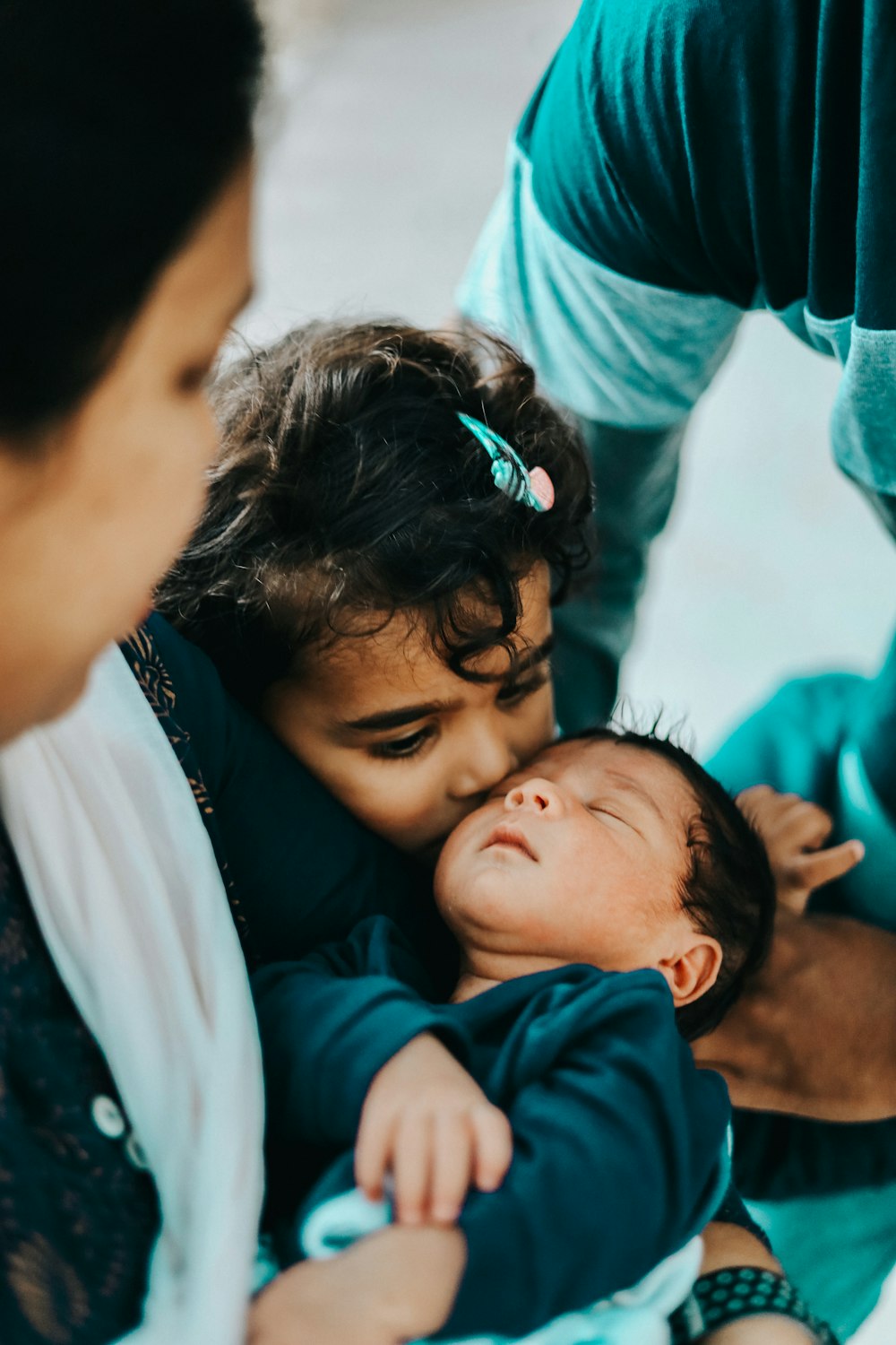 a woman holding a baby in her arms