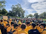 Photo showing a group wearing matching community event shirts outdoors.