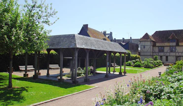 a gazebo in the middle of a lush green park