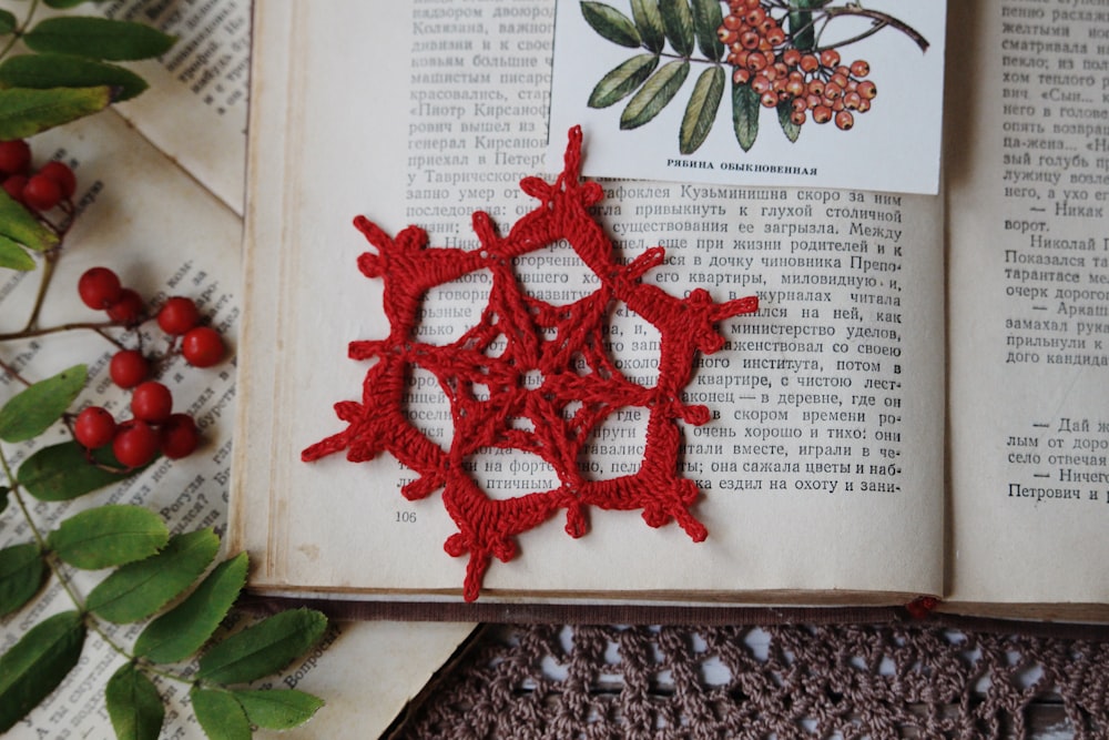 a crocheted snowflake on top of an open book
