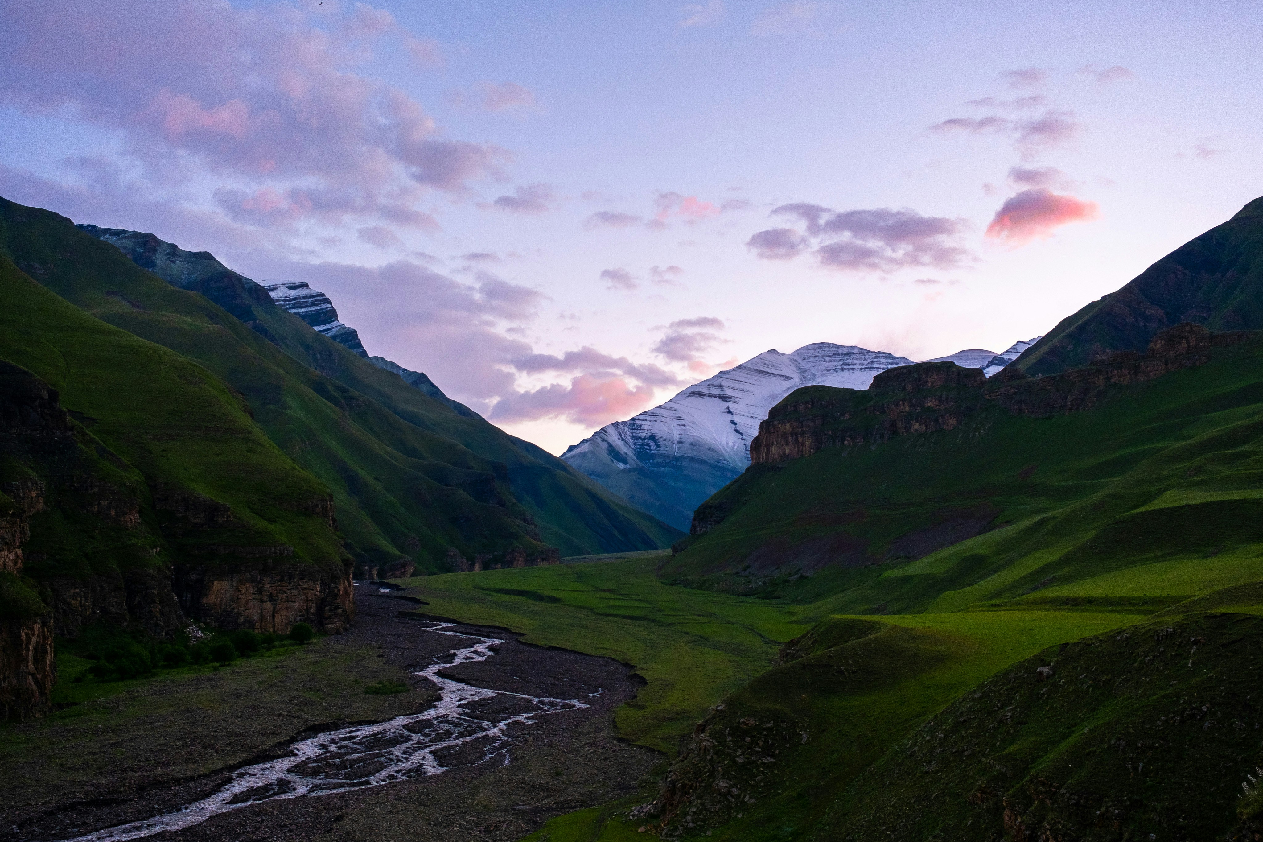 a river running through a lush green valley