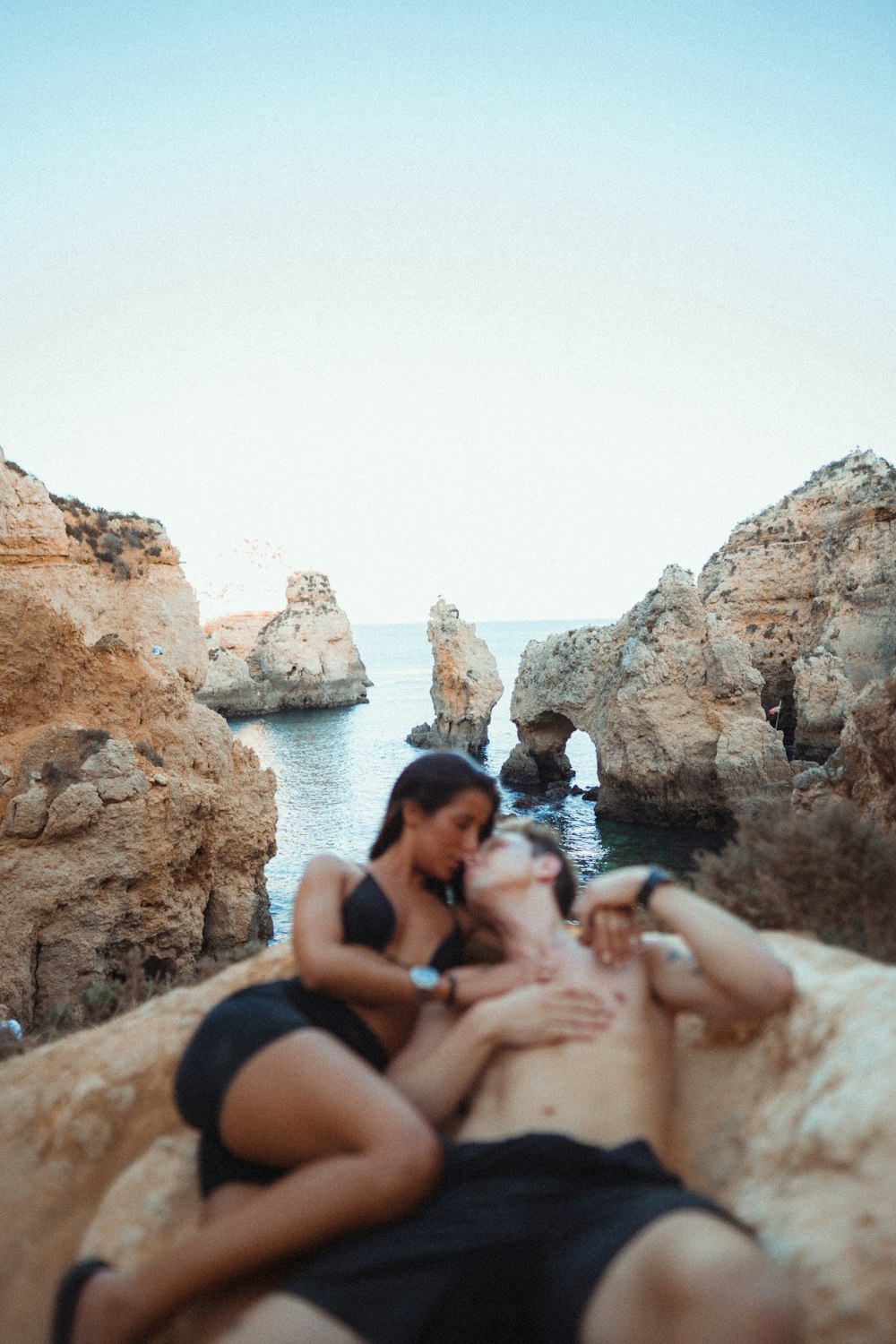 a group of people sitting on a rock