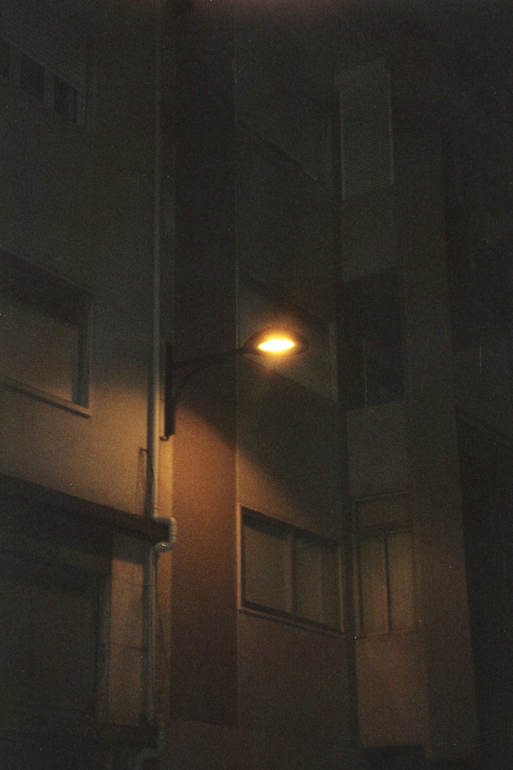 a street light shines on the side of a building