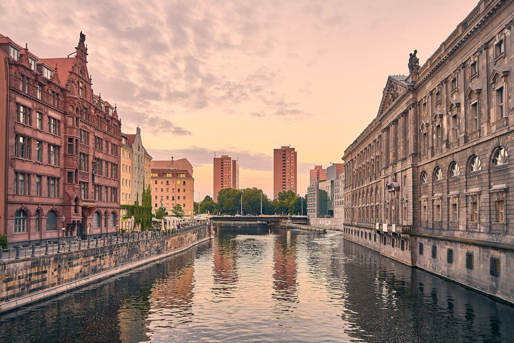 a river running through a city next to tall buildings