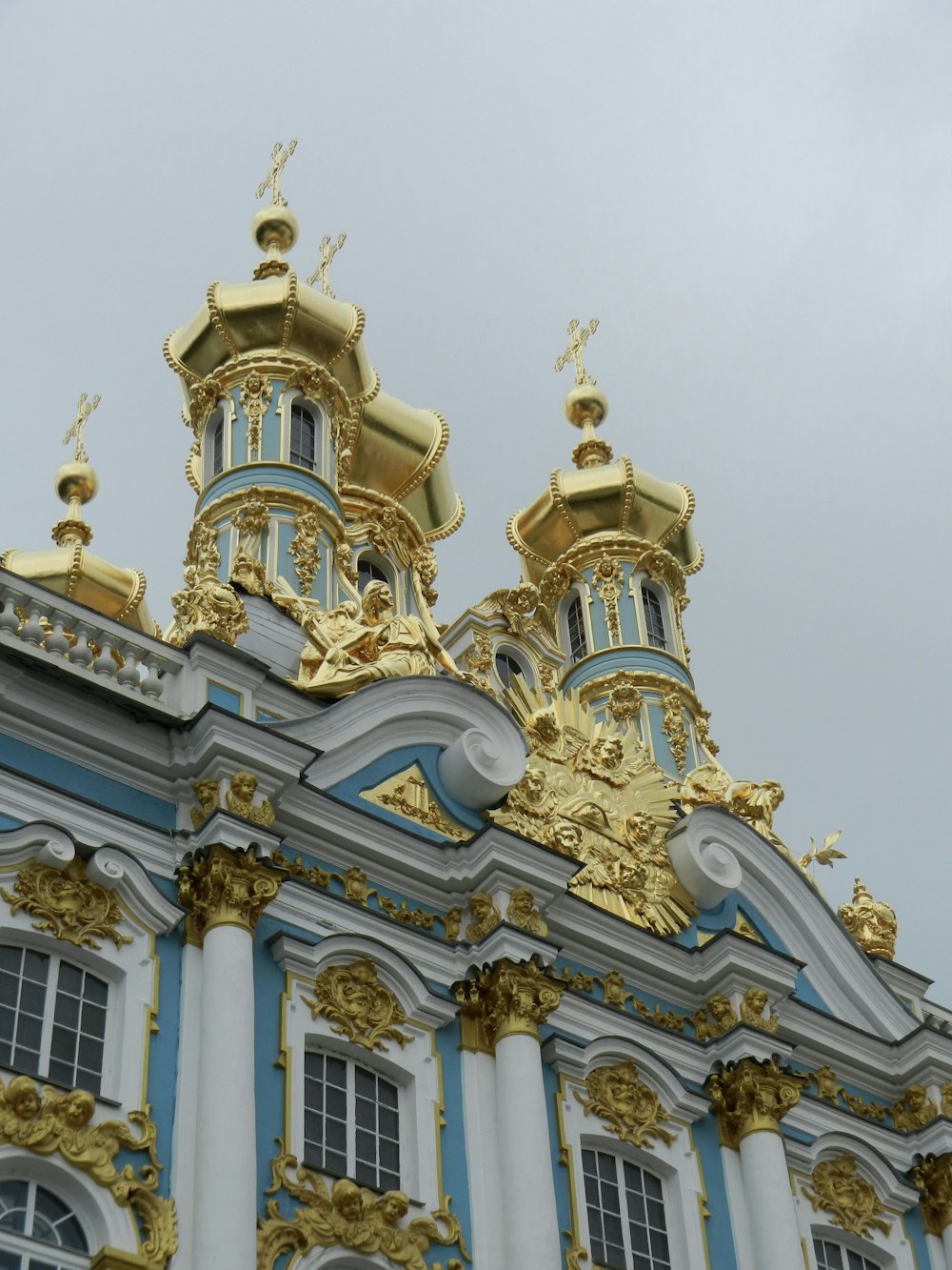 a large building with gold and blue decorations on top of it