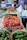 Close-up of hands selecting fresh Italian produce at a local market stall.