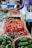 Close-up of hands selecting fresh Italian produce at a local market stall.