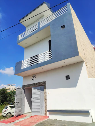 A welcoming real estate agent showing a happy family their new home in Uttam Nagar.