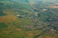 An aerial shot showing a patchwork of farmland and development sites near a small town.