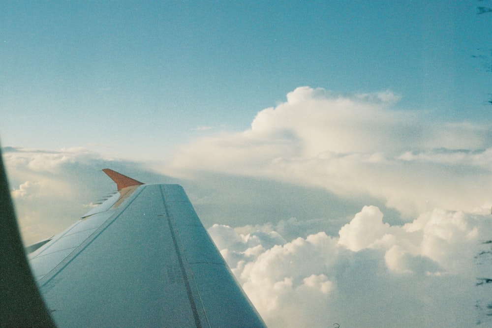 the wing of an airplane flying above the clouds