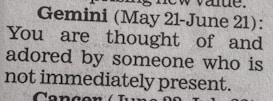 A close-up of a newspaper horoscope section, specifically the entry for Gemini from May 21 to June 21. It predicts that someone who is not present thinks of and adores the reader.