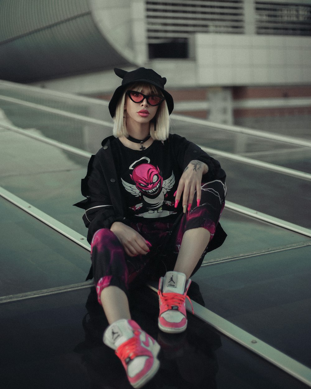 a woman sitting on top of a black surface