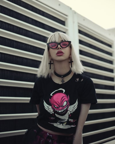 Fashionable-looking girl with blond hair and pink sunglasses