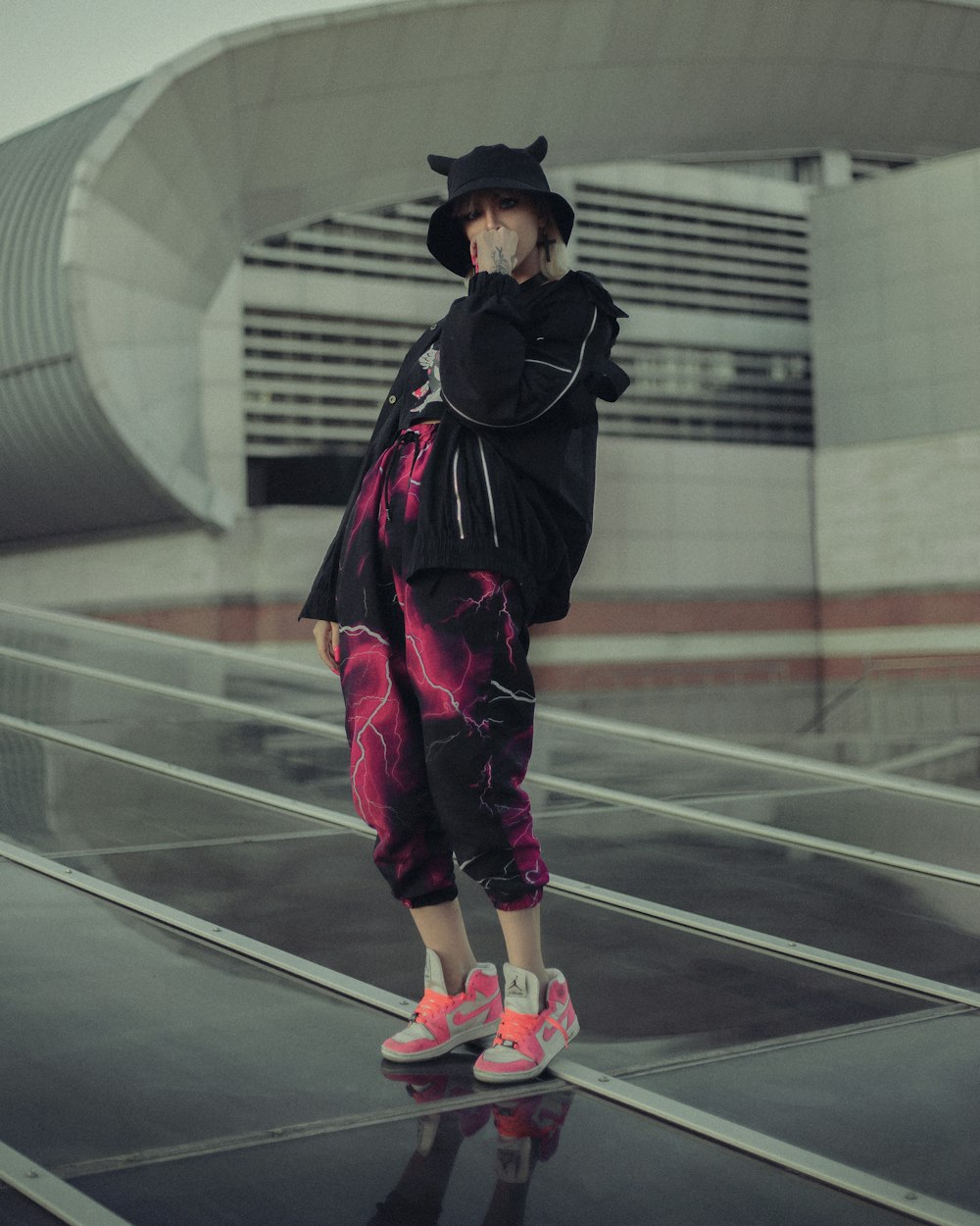 a woman standing on a skateboard in front of a building