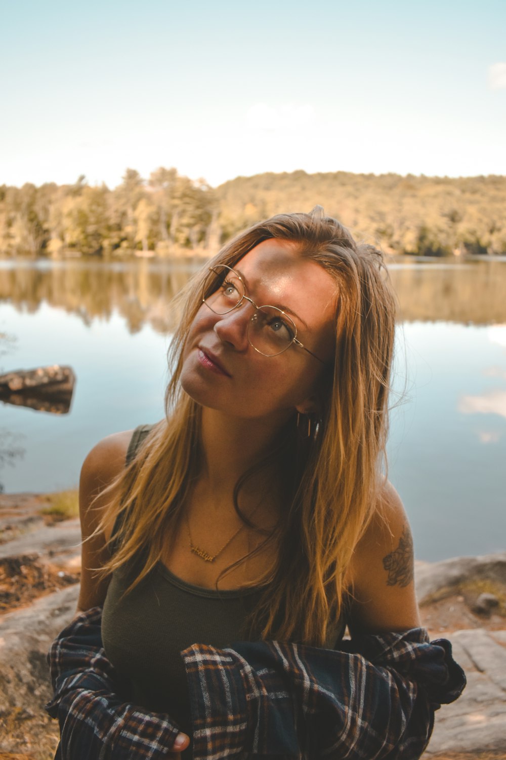 a woman standing in front of a body of water