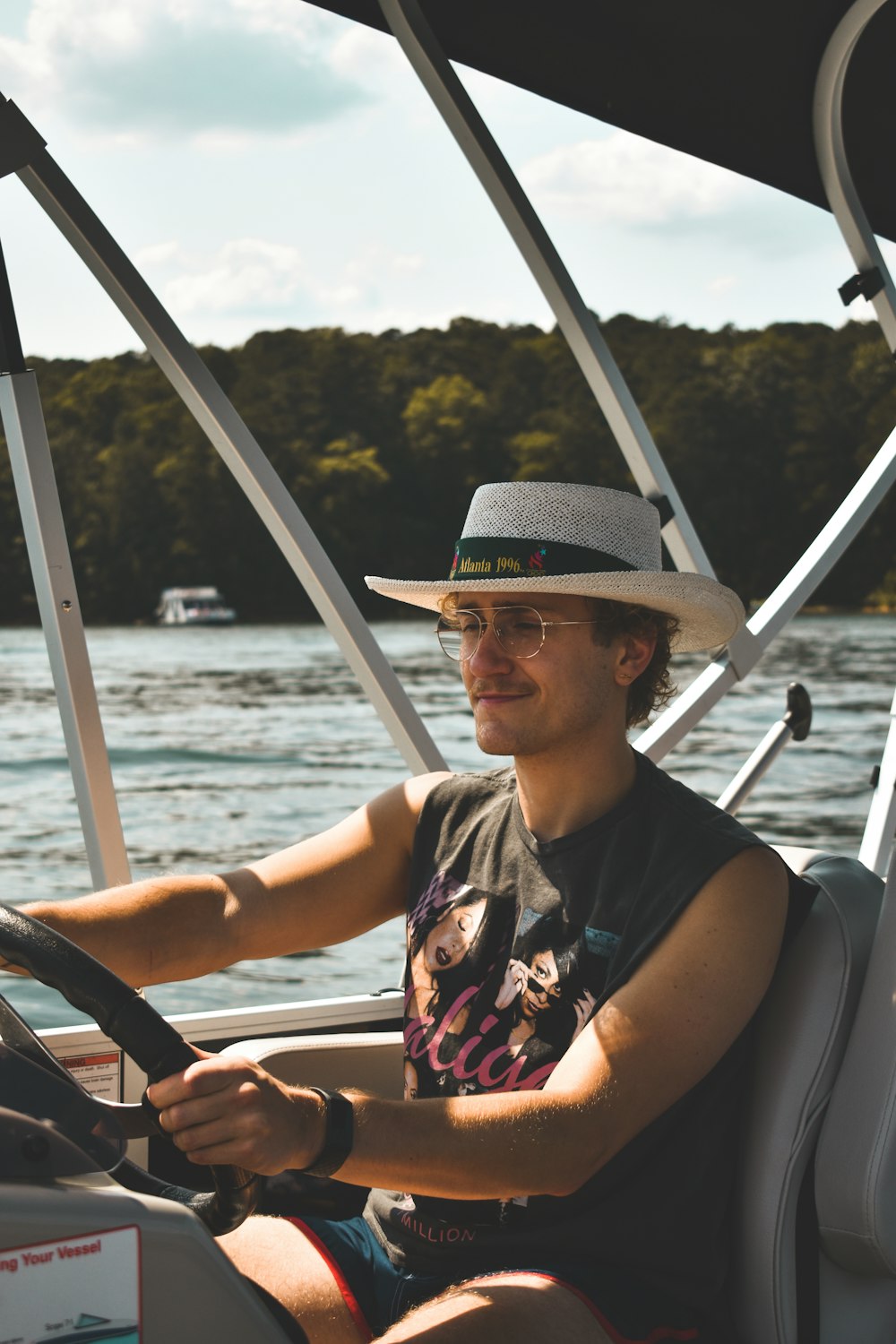 a man driving a boat on a body of water