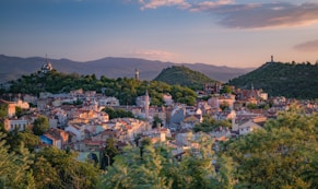 a small town surrounded by trees and mountains