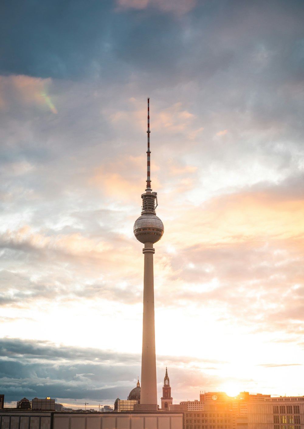 a very tall tower with a very tall clock on it's side