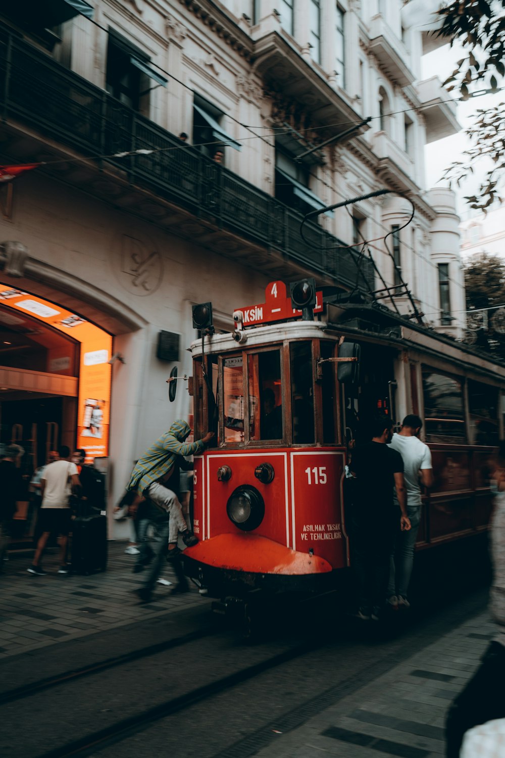 a red trolley car on a city street