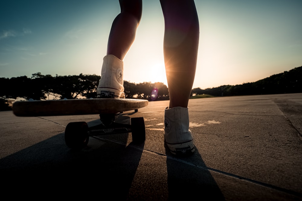 a person riding a skateboard down a street