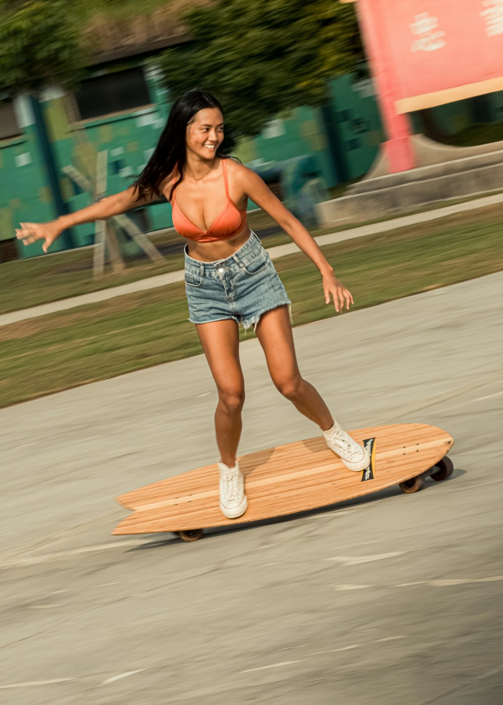 a woman riding a skateboard down a street