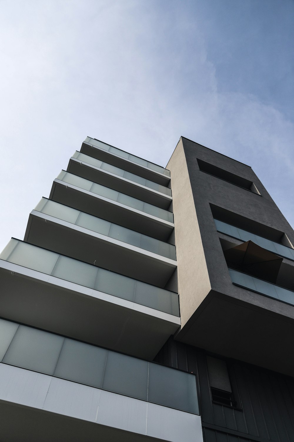 a tall building with balconies against a blue sky