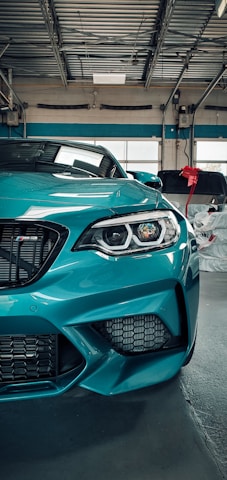 a blue sports car parked in a garage