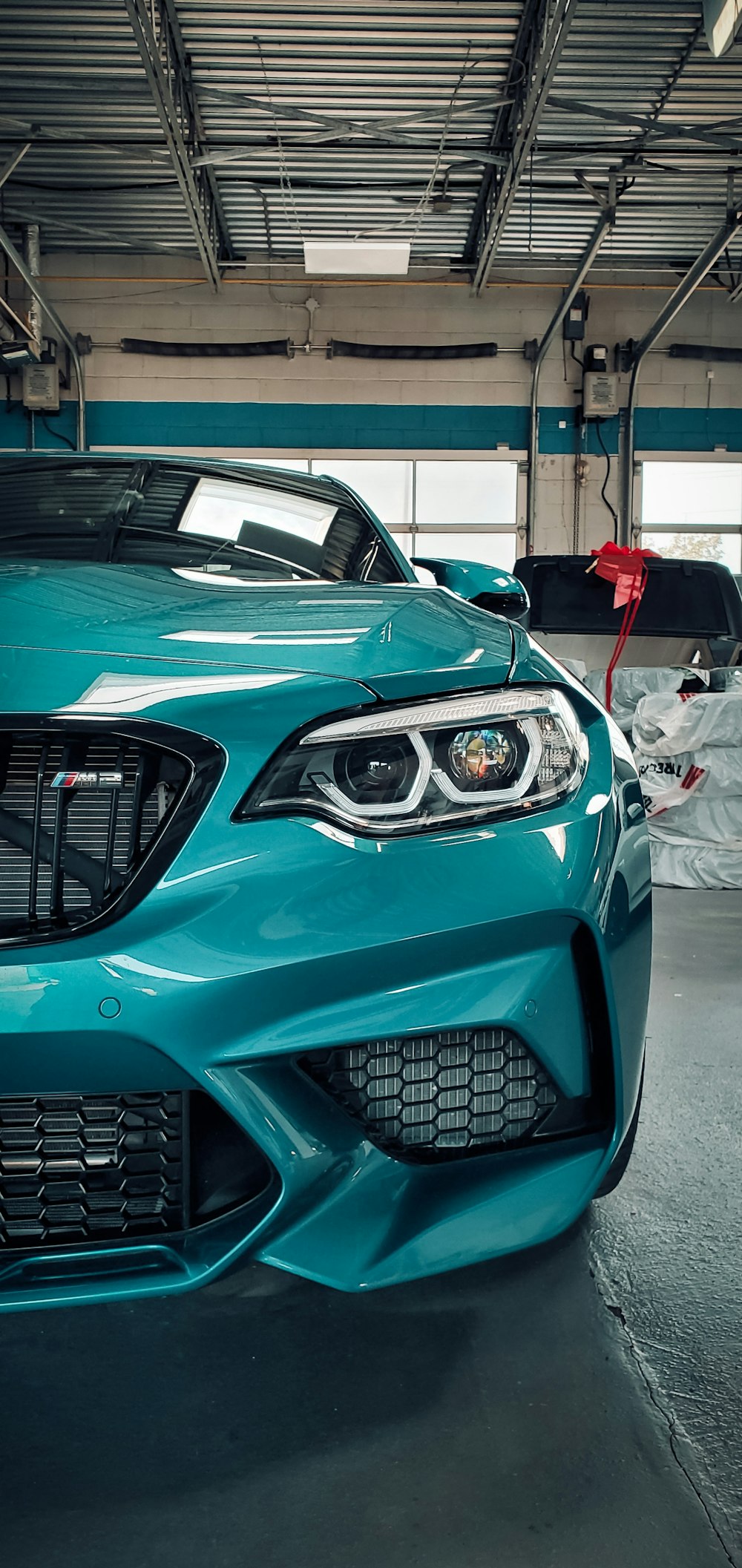 a blue sports car parked in a garage