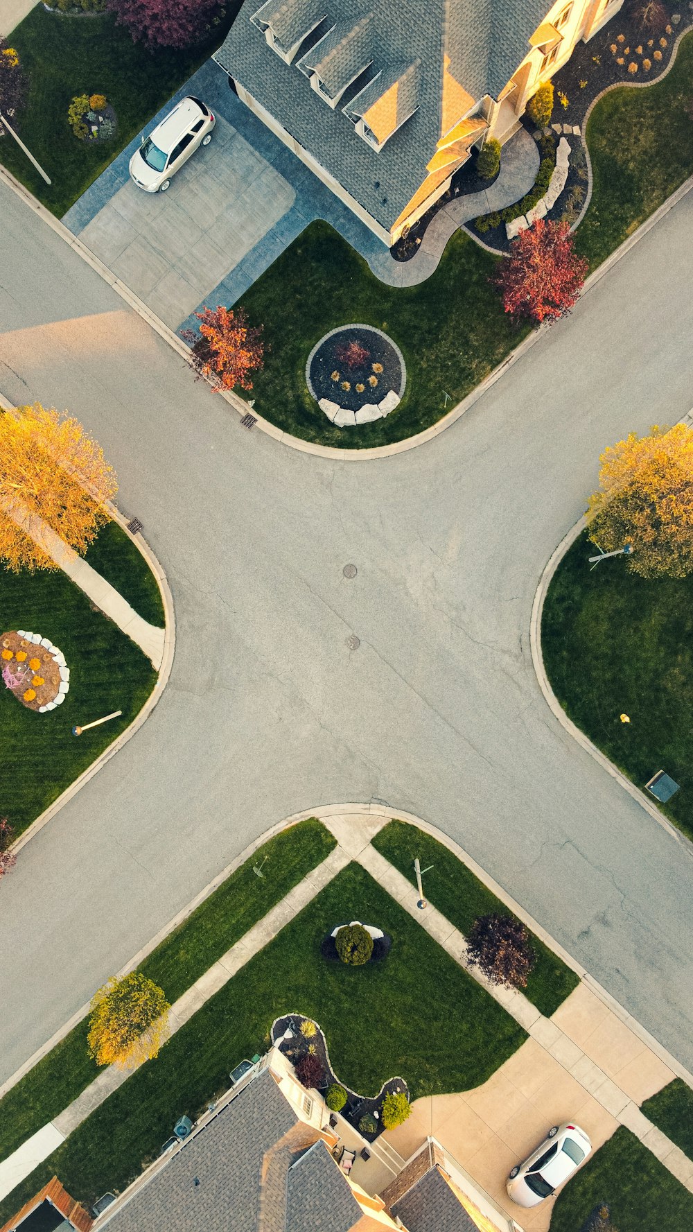 an aerial view of a street intersection in a neighborhood