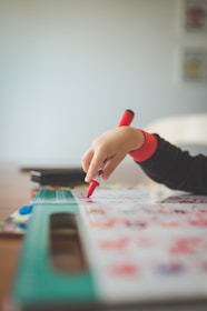 a child is drawing on a piece of paper