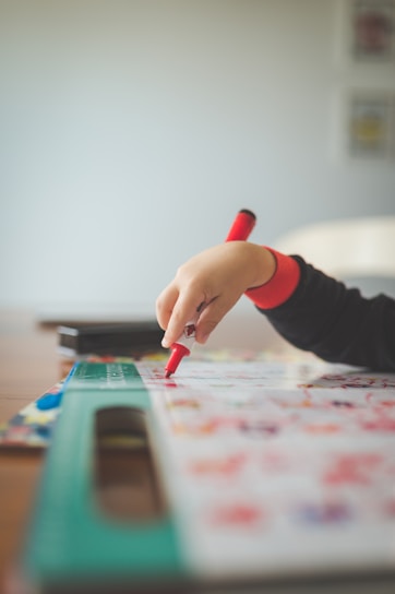 a child is drawing on a piece of paper