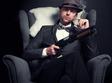 a man in a tuxedo smoking a cigarette