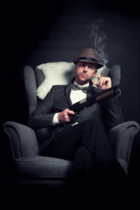 a man in a tuxedo smoking a cigarette