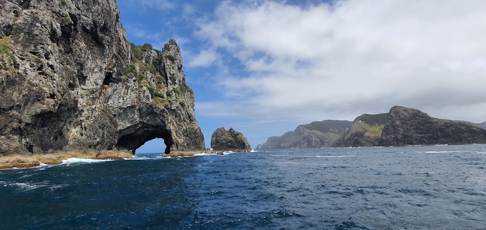 a large rock formation in the middle of a body of water