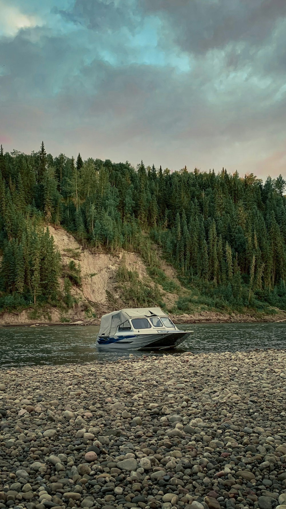 a boat on a river near a forest