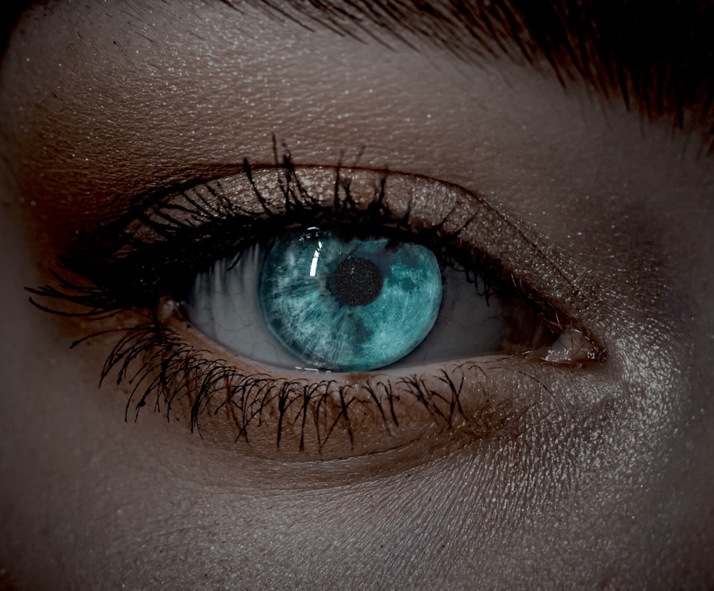 a close up of a person's blue eye