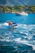 A happy couple enjoying a private boat tour in Paraty with lush green islands in the background.