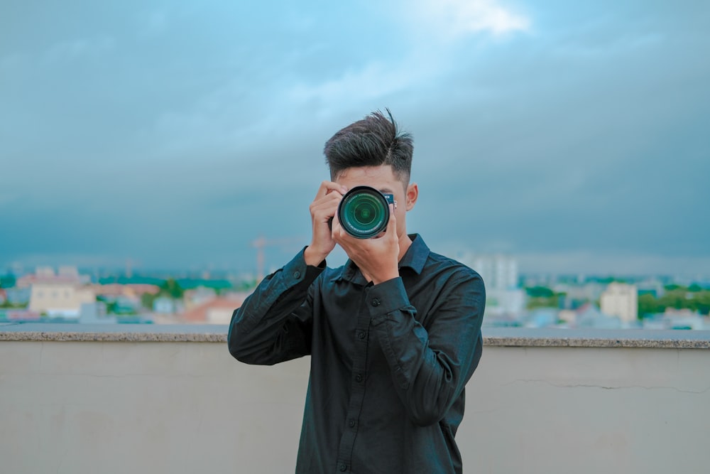 a man holding a camera up to his face