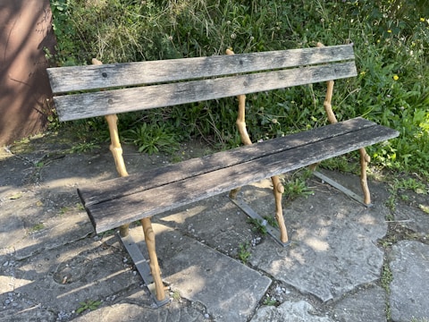 Rustic wooden bench with smooth finish and sturdy legs.